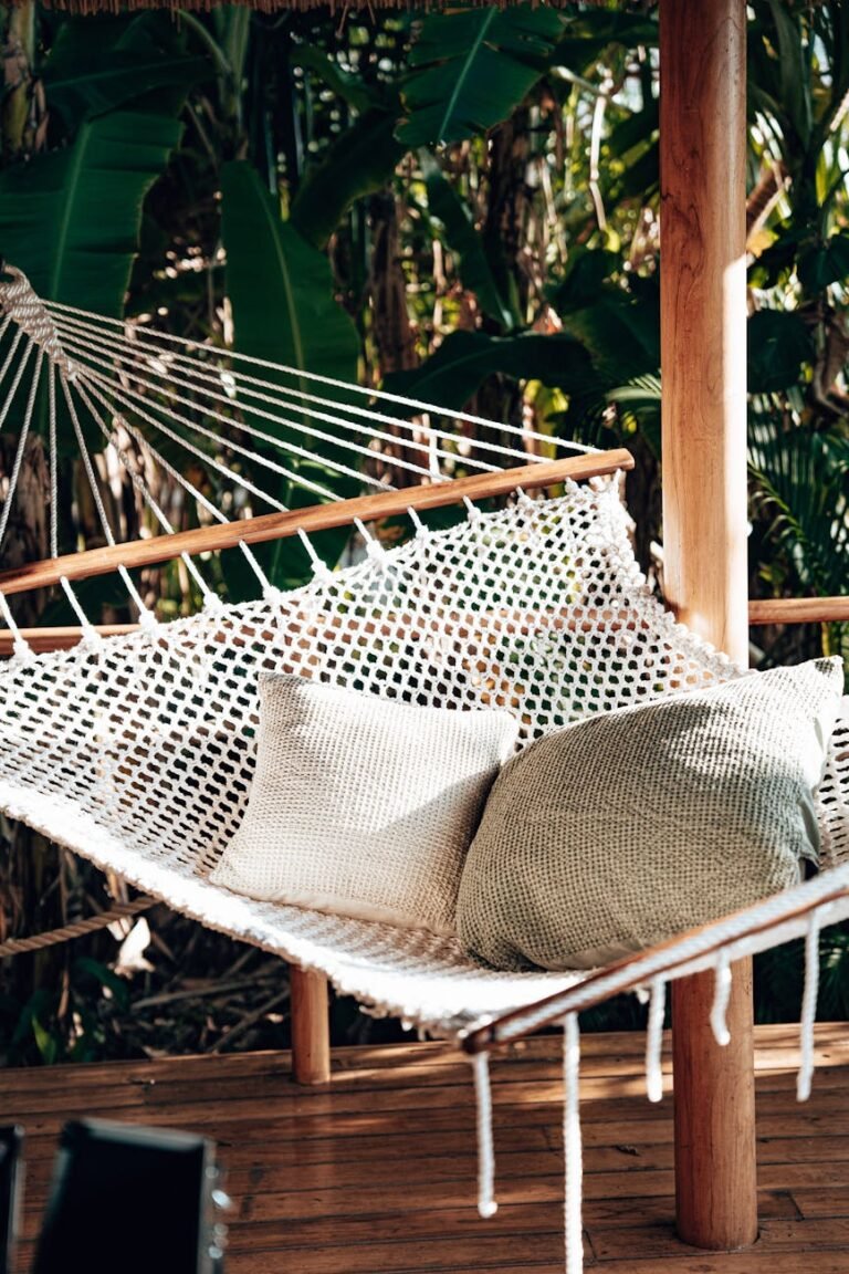 a white hammock on a wooden verandah