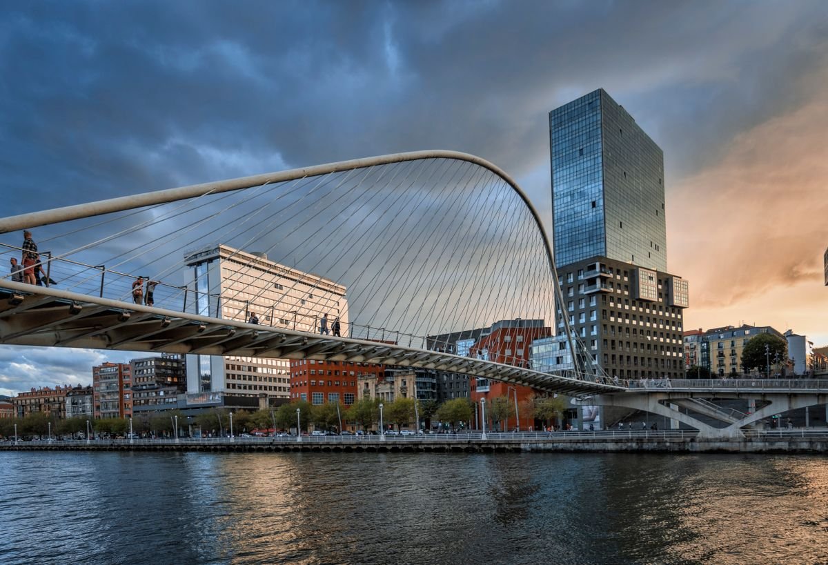 Zubizuri footbridge crossing the river in Bilbao at dusk