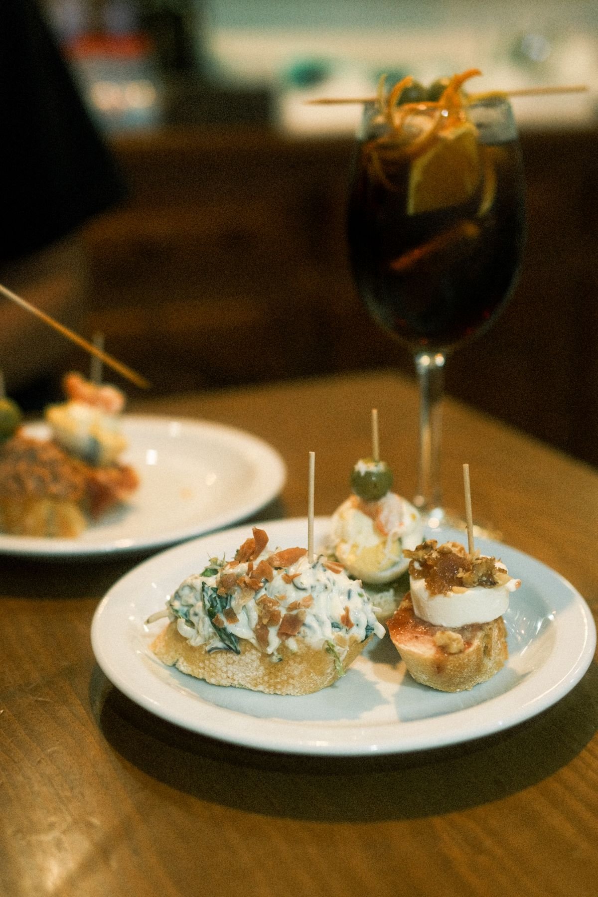 Pintxos and a drink on a warmly lit table