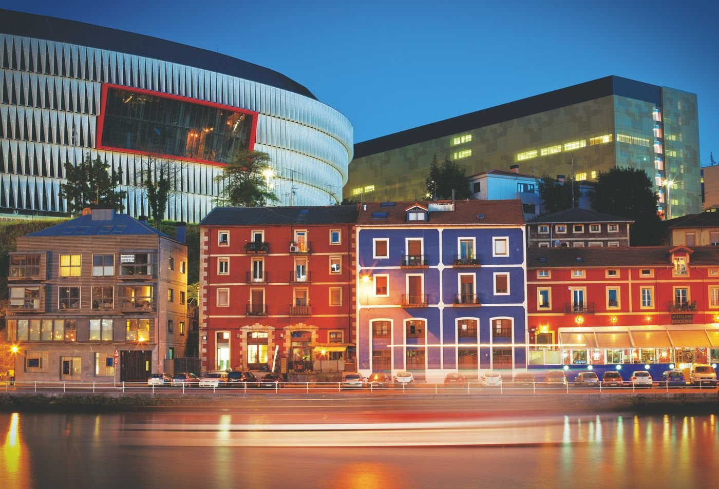 Bilbao glowing beside the river after dark