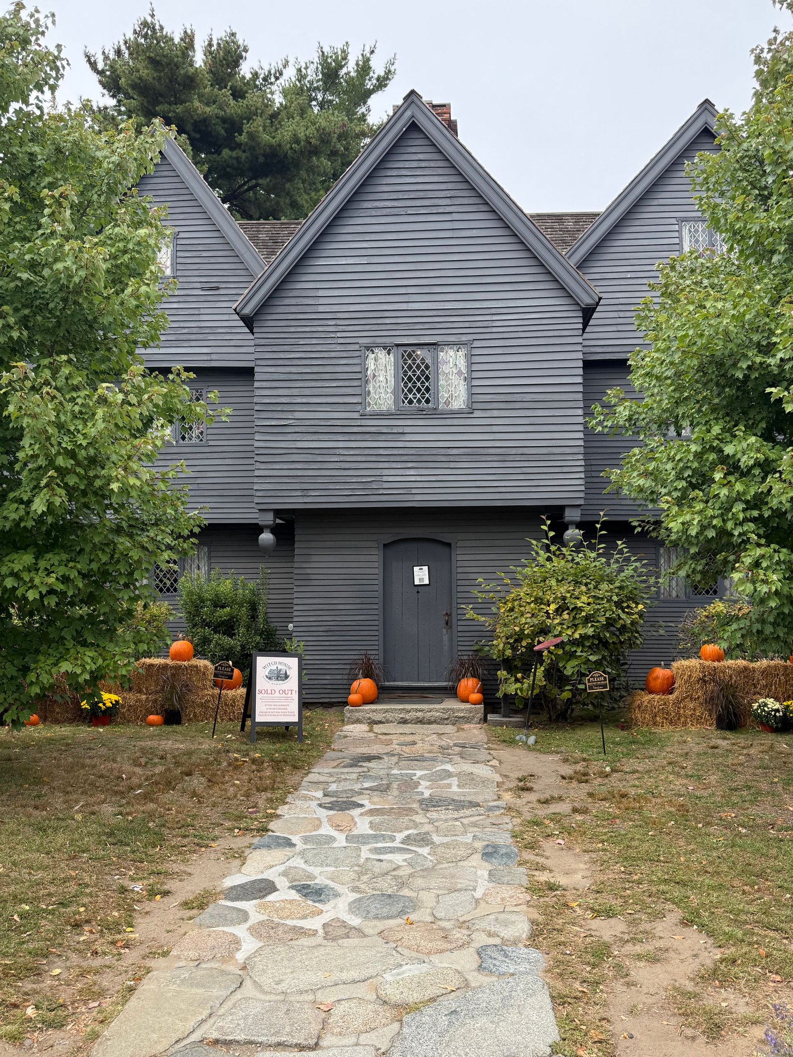 The iconic Witch House in Salem, Massachusetts, adorned with pumpkins and fall decor.
